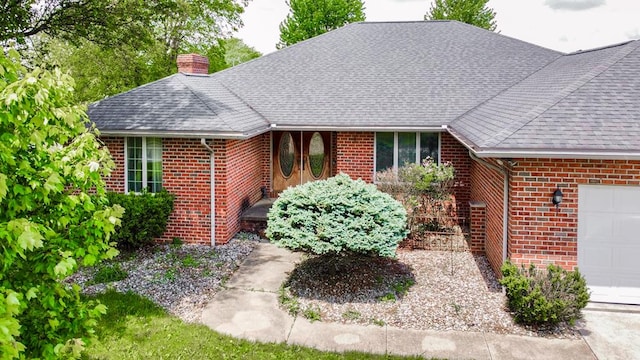 1320 Oakridge Rd, Bucyrus, OH 44820 - ranch-style home with brick siding, a chimney, roof with shingles, and a garage