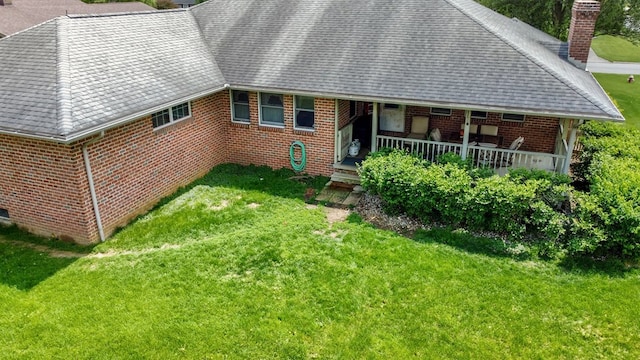1320 Oakridge Rd, Bucyrus, OH 44820 - view of front of home featuring a chimney, brick siding, a front lawn, and a shingled roof