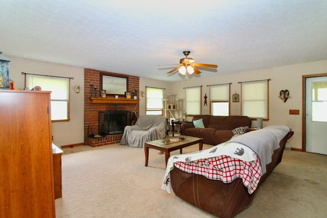 1320 Oakridge Rd, Bucyrus, OH 44820 - carpeted living room featuring healthy amount of natural light, a ceiling fan, a fireplace, baseboards, and a textured ceiling
