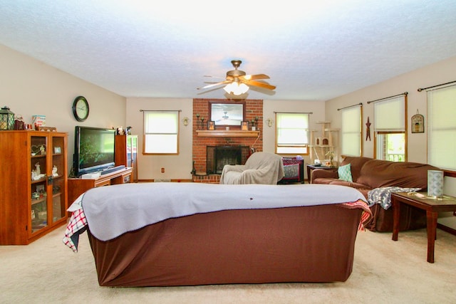 1320 Oakridge Rd, Bucyrus, OH 44820 - living area with light colored carpet, a ceiling fan, a fireplace, and a textured ceiling