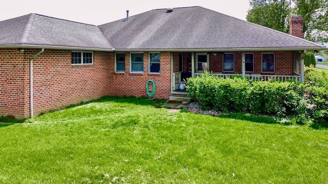 1320 Oakridge Rd, Bucyrus, OH 44820 - back of property featuring a chimney, brick siding, a lawn, and roof with shingles