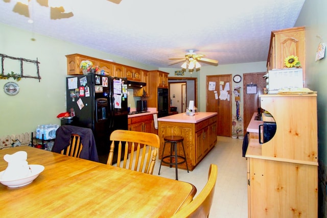 1320 Oakridge Rd, Bucyrus, OH 44820 - dining room with ceiling fan, light floors, and a textured ceiling