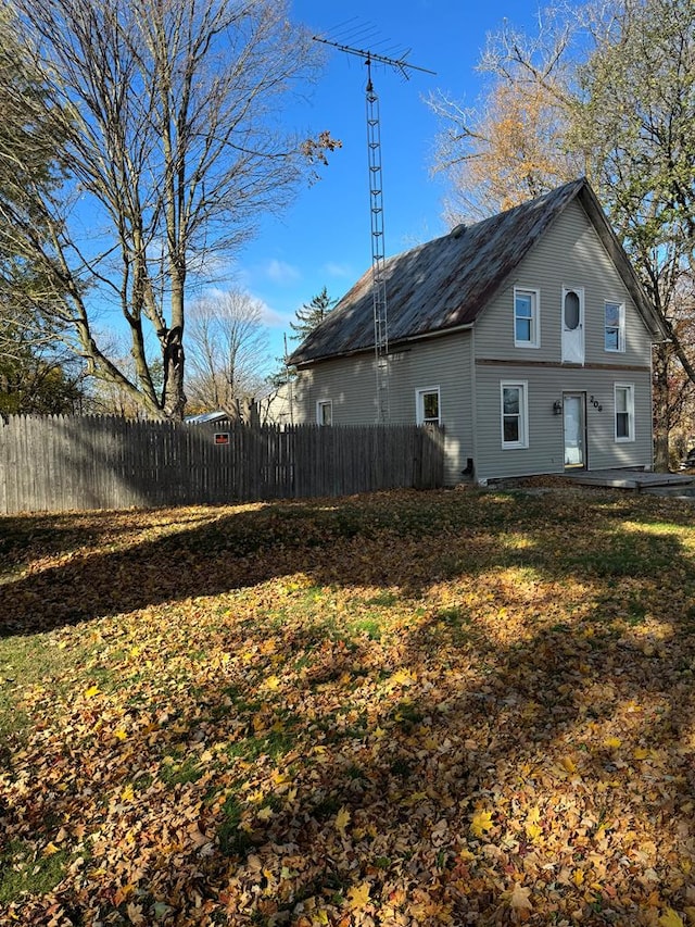 rear view of house with a yard