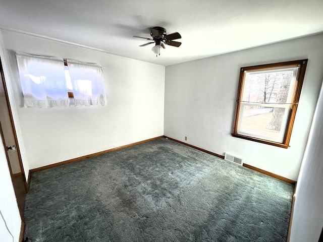 unfurnished room with visible vents, ceiling fan, baseboards, and carpet floors