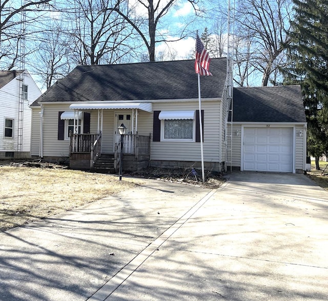 view of front of home featuring a garage, driveway, and a shingled roof