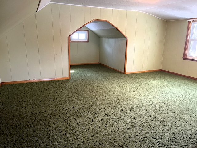 additional living space featuring carpet flooring and baseboards