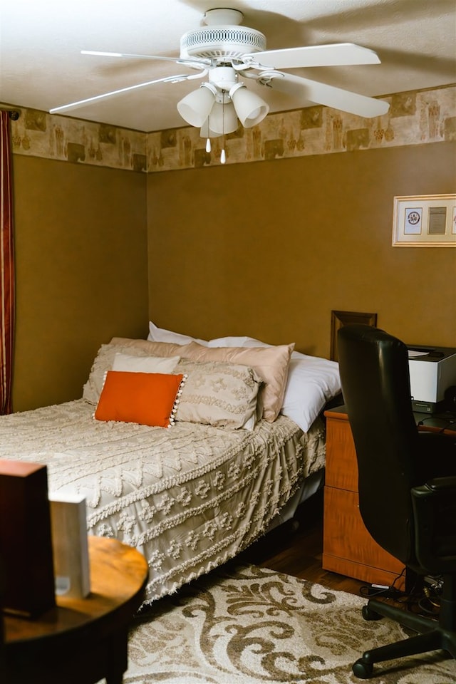 bedroom featuring a ceiling fan and wood finished floors