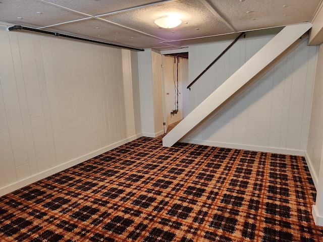 basement featuring wood walls