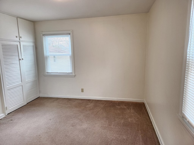 unfurnished bedroom featuring carpet flooring and a closet