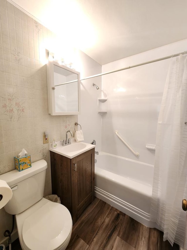 full bathroom featuring vanity, backsplash, hardwood / wood-style flooring, shower / bath combo with shower curtain, and tile walls