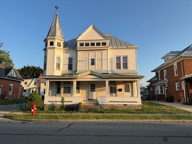 325 E Mansfield St, Bucyrus, OH 44820 - victorian home with a standing seam roof, a porch, and a metal roof