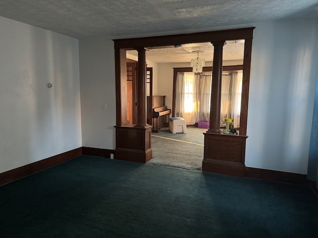 325 E Mansfield St, Bucyrus, OH 44820 - carpeted empty room with ornate columns, a chandelier, and a textured ceiling