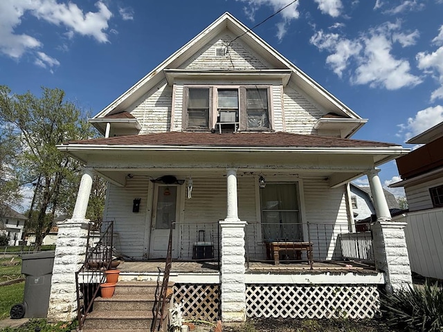 victorian home featuring covered porch and central AC