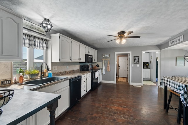 kitchen featuring backsplash, black appliances, sink, a textured ceiling, and white cabinetry