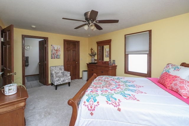 bedroom with a ceiling fan, carpet floors, and ensuite bathroom