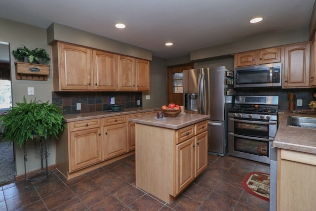 kitchen with a center island, tasteful backsplash, appliances with stainless steel finishes, and light brown cabinets