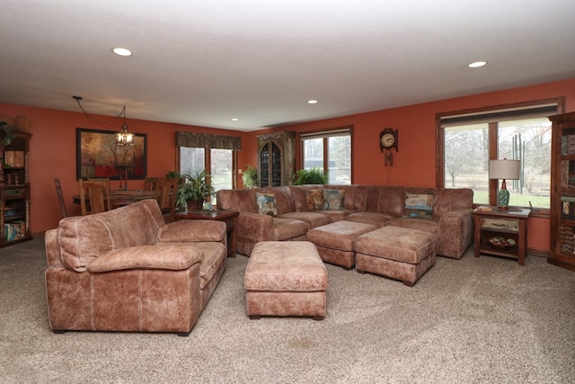 living area featuring carpet flooring, a notable chandelier, and recessed lighting