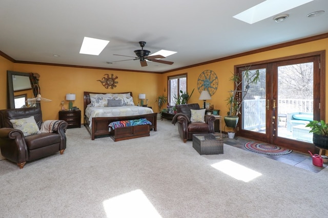 bedroom with carpet floors, access to exterior, crown molding, and a skylight