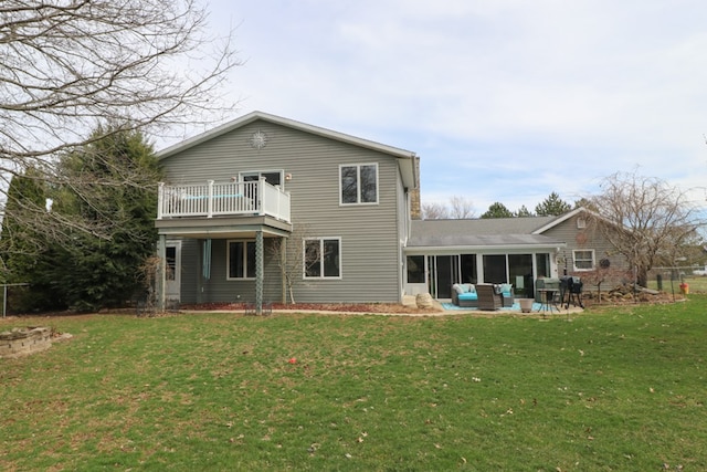 rear view of property with an outdoor living space, a sunroom, a patio, and a yard