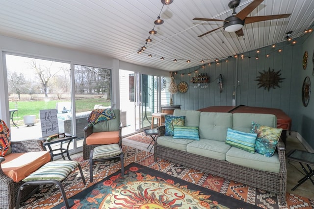 sunroom featuring an outdoor living space and a ceiling fan