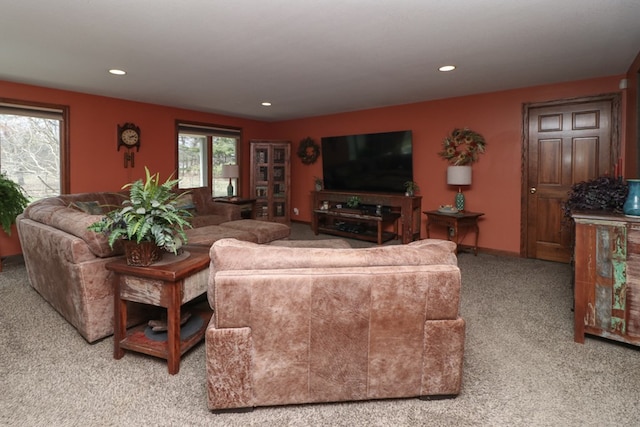 living area featuring light carpet, baseboards, and recessed lighting