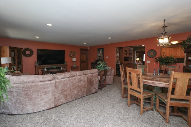 dining space featuring light carpet, a notable chandelier, and recessed lighting