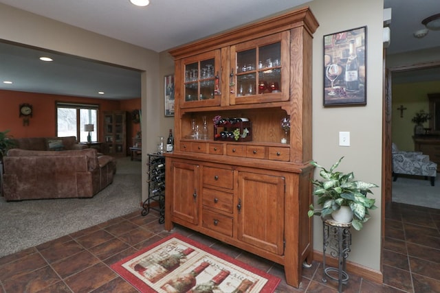 bar with baseboards, dark colored carpet, and recessed lighting
