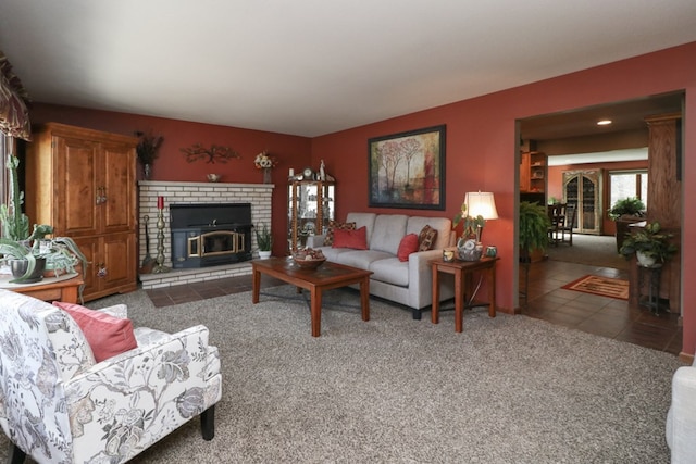 carpeted living room featuring tile patterned flooring and a brick fireplace