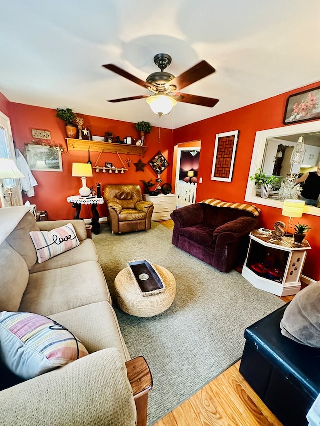 living room featuring ceiling fan and hardwood / wood-style floors