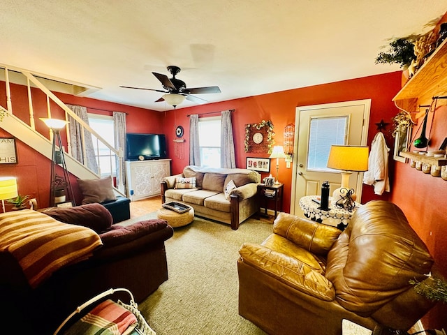 living room with ceiling fan and carpet