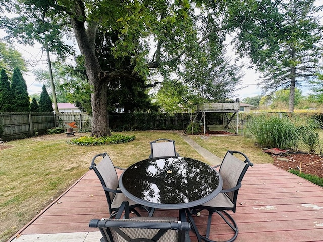 wooden terrace featuring a lawn