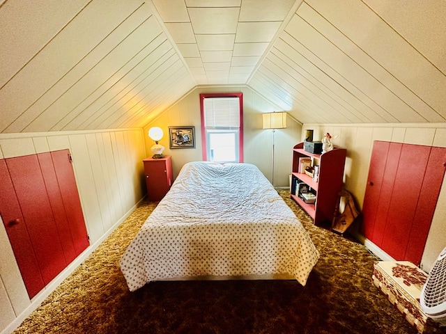 carpeted bedroom featuring wood walls and vaulted ceiling