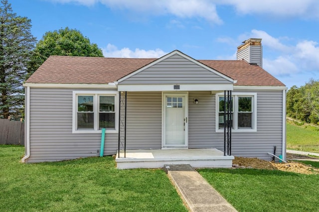 bungalow featuring a porch and a front lawn