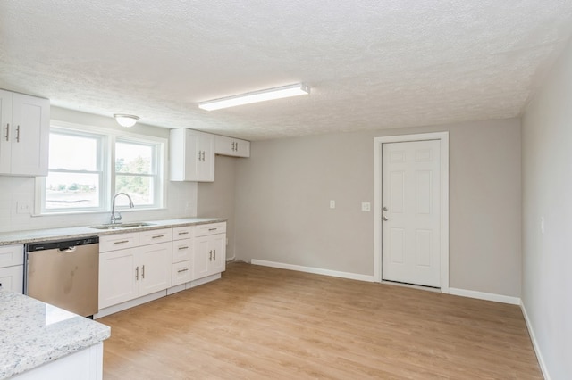 kitchen with backsplash, stainless steel dishwasher, a textured ceiling, sink, and white cabinetry