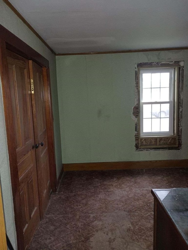 unfurnished room with ornamental molding