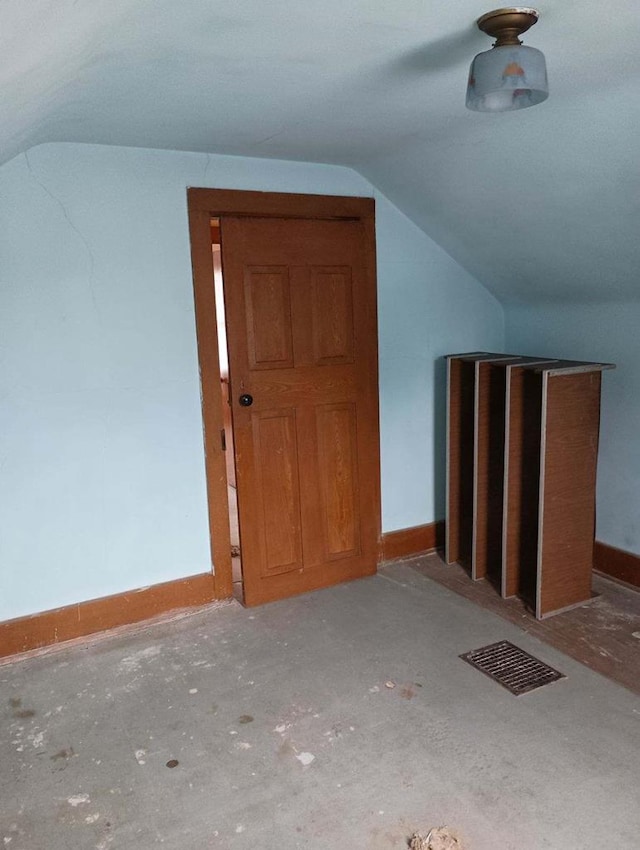 additional living space featuring lofted ceiling