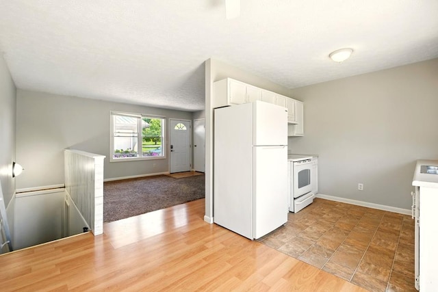 560 Harlan Rd, Mansfield, OH 44843 - kitchen with white appliances, white cabinets, baseboards, light countertops, and open floor plan
