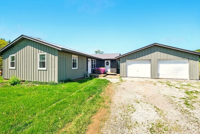 560 Harlan Rd, Mansfield, OH 44843 - ranch-style house featuring board and batten siding and an attached garage