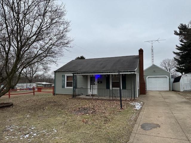 view of front of property featuring a garage and an outbuilding