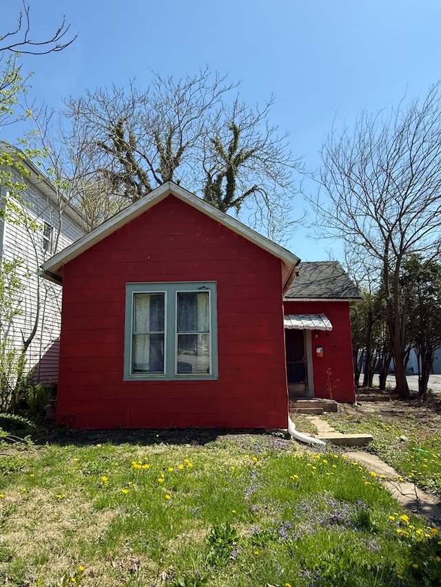 view of home's exterior with a lawn and concrete block siding