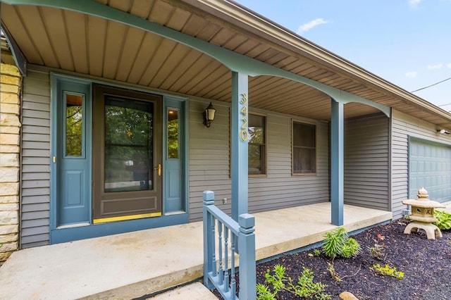 doorway to property with a porch and an attached garage