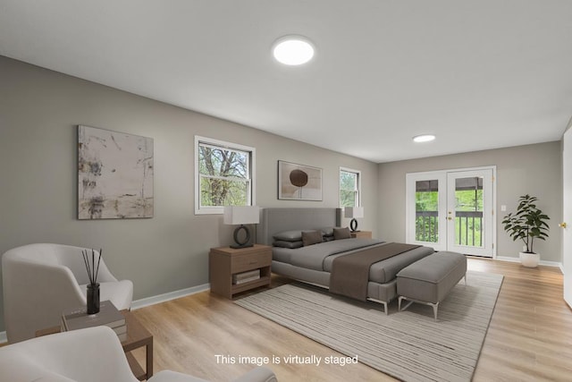 bedroom with access to exterior, multiple windows, baseboards, and light wood-style floors