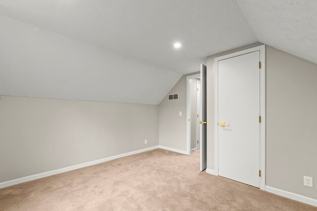 bonus room with light colored carpet, lofted ceiling, baseboards, and recessed lighting