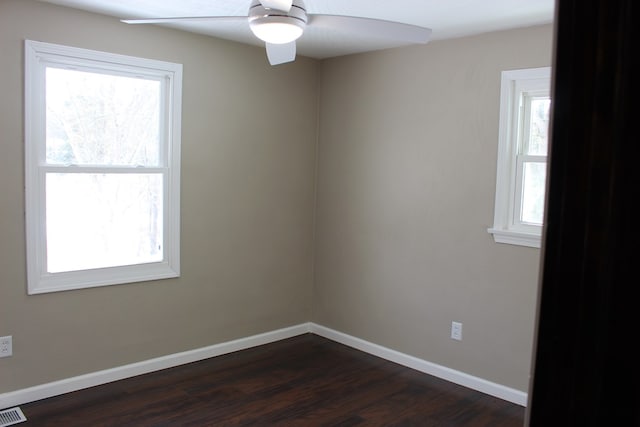 unfurnished room with ceiling fan and dark hardwood / wood-style floors