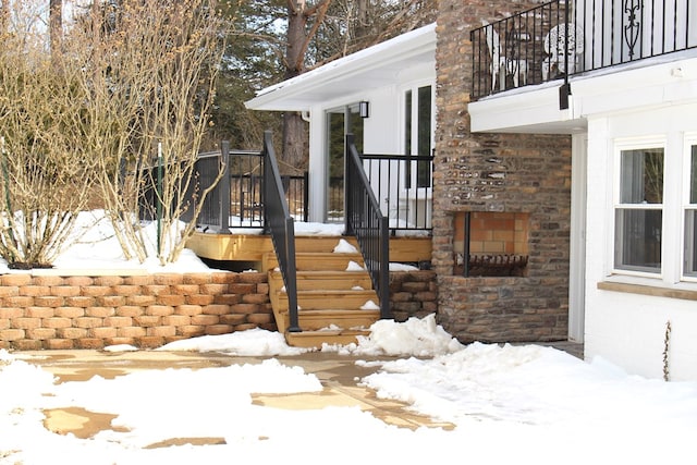 view of snow covered property entrance