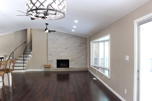 unfurnished living room featuring wood-type flooring, lofted ceiling, and a fireplace