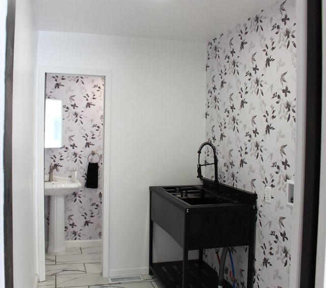 interior space featuring baseboards and marble finish floor