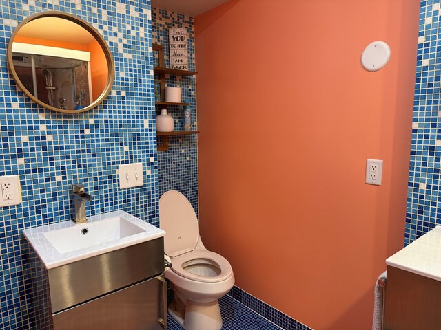 380 Tidd Dr, Galion, OH 44833 - bathroom featuring vanity, tile patterned floors, and tile walls