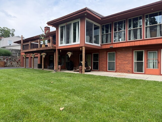380 Tidd Dr, Galion, OH 44833 - back of house featuring a yard, brick siding, and a patio