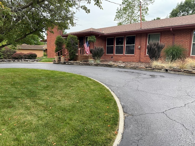 380 Tidd Dr, Galion, OH 44833 - single story home with brick siding, a front yard, driveway, and a shingled roof